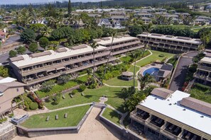 A resort with multiple-story buildings, a swimming pool, and well-maintained lawns. - OCEAN VIEW 2 Bdrm condo with Secluded Beach - Kahana Sunset C7 (Lahaina)