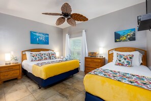 A hotel room with two beds, a ceiling fan, and artwork on the walls. - OCEAN VIEW 2 Bdrm condo with Secluded Beach - Kahana Sunset C7 (Lahaina)