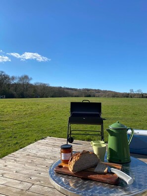 Enjoy a peaceful picnic in our serene outdoor setting, complete with a grill and picnic table.