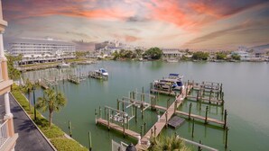 A marina with boats docked, a dock area, and a cityscape in the background.