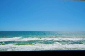 A view of the ocean from a window. - The Oyster | Beachfront Condo (Destin)