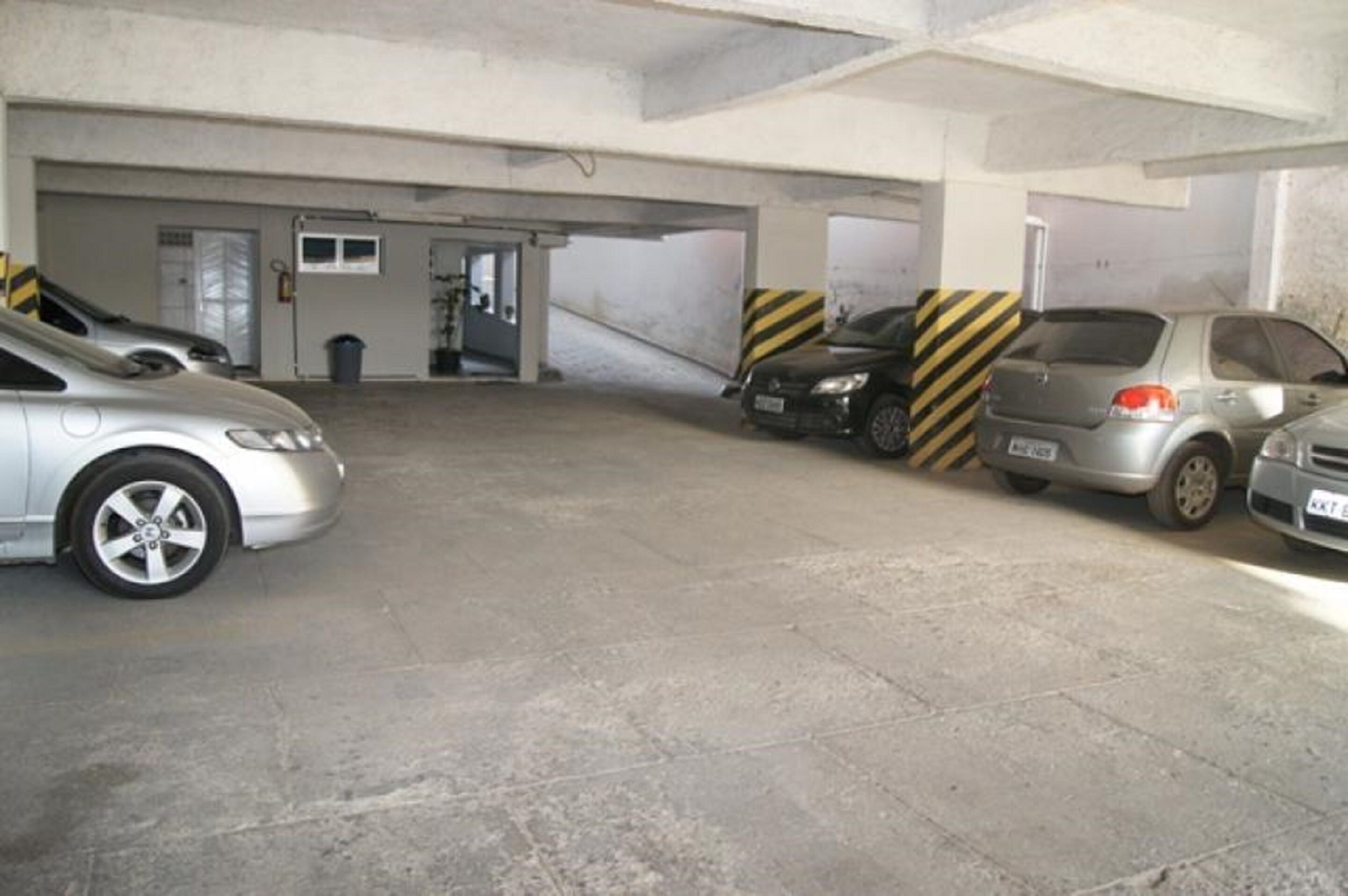A parking garage with multiple cars parked.