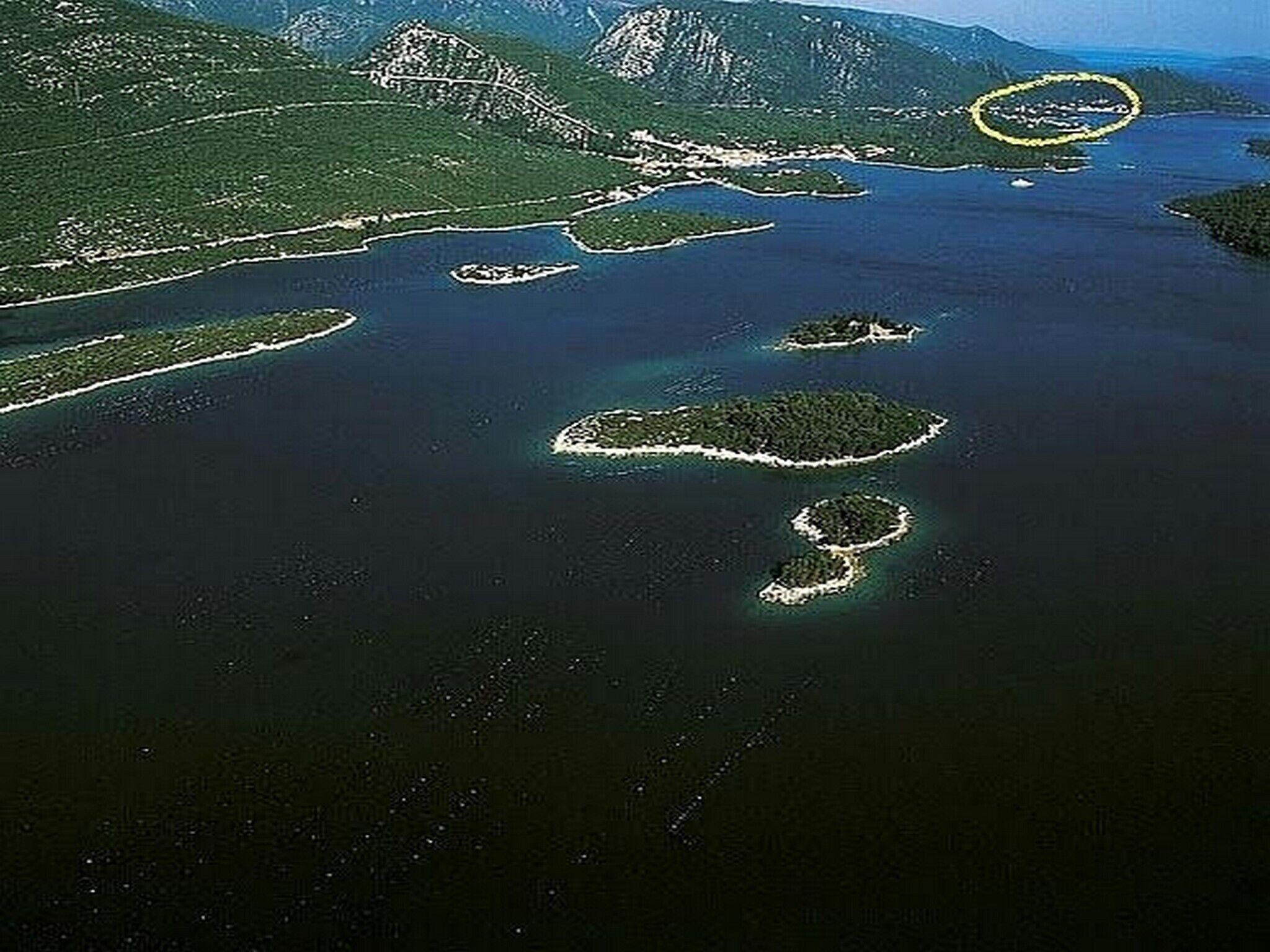 An aerial view of a coastal area with multiple islands surrounded by water.