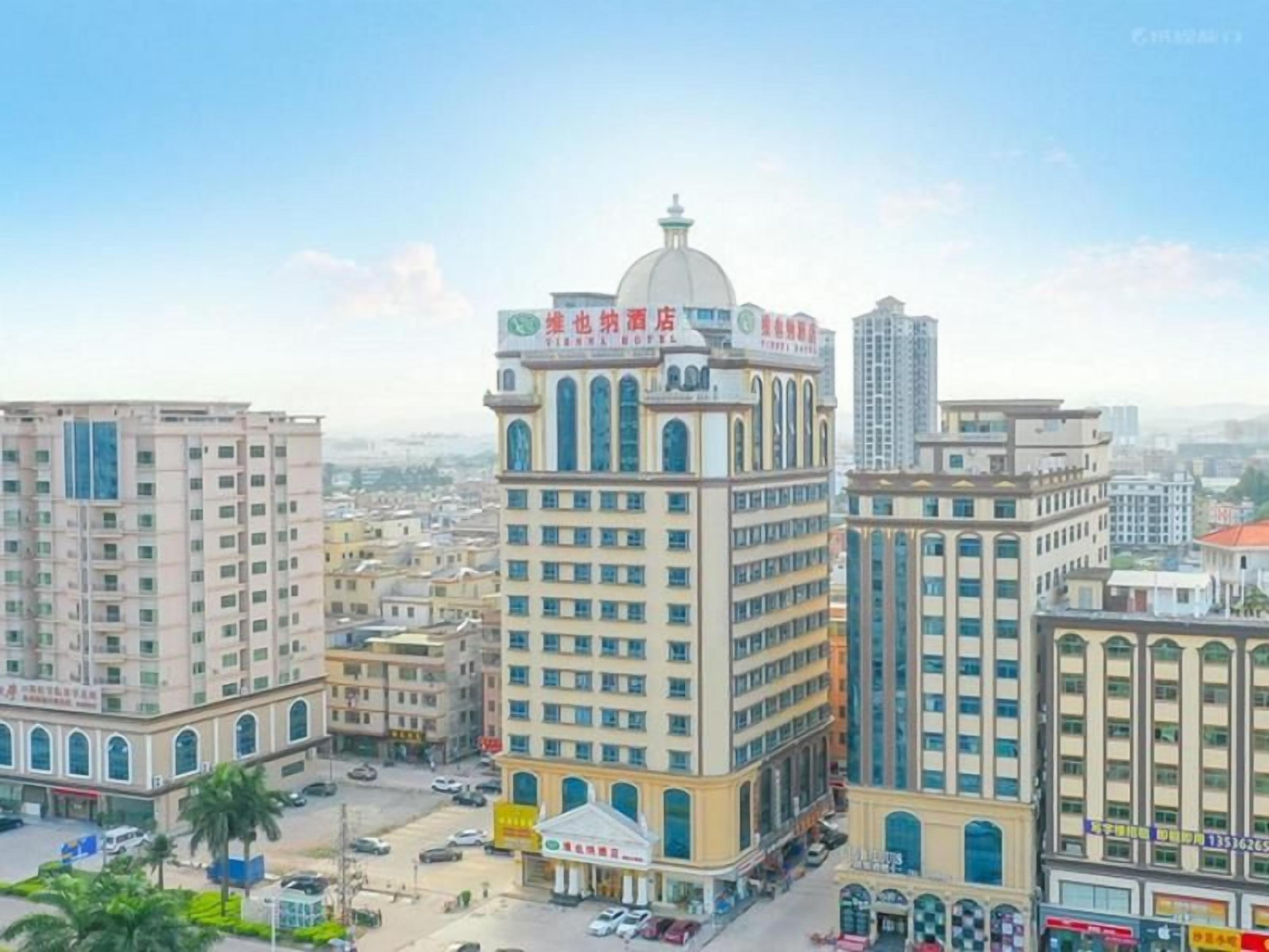 A multi-story hotel with a prominent dome and arched windows, surrounded by other buildings in an urban setting.