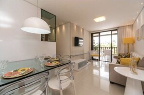 Enjoy a serene retreat with a glass dining table, comfortable sofa, and expansive outdoor views.