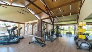 A gym with treadmills, elliptical machines, and stationary bikes.