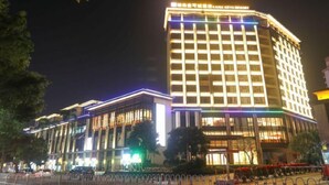 A multi-story hotel with illuminated signage and a modern facade.