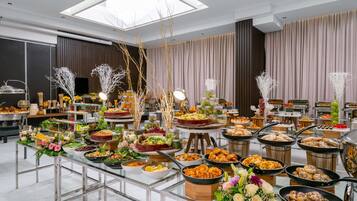 A buffet setup with various food items and decorative elements.
