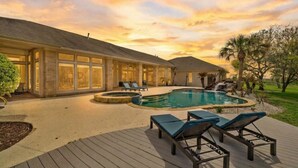 A house with a swimming pool, deck, and lounge chairs. - Luxurious Secluded Estate with Pool & Pond (Galveston)