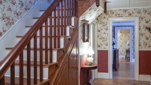 A wooden staircase with a lamp on a small table at the landing. - Charming estate on Norwich Green, near casinos (Norwich)