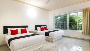 A hotel room with two beds, a ceiling fan, a window with a view of greenery, and a tiled floor. - Hotel Parotas Manzanillo (Manzanillo)