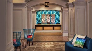 A hallway with a bench, two chairs, and a blue sofa. - Marriott's OceanWatch Two Bedroom Beachfront Resort (Myrtle Beach)