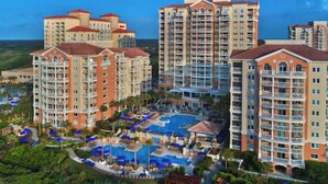 A resort with multiple high-rise buildings, a central pool area with sun loungers, and a landscaped garden. - Marriott's OceanWatch Two Bedroom Beachfront Resort (Myrtle Beach)