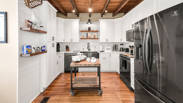 A modern kitchen with white cabinets, a wooden table, a stainless steel refrigerator, and a wooden ceiling. - Welcome to the Rusty Rose-Restored Farmhouse feel in the heart of Jefferson, MD (Jefferson)