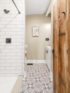 Bathtub, hair dryer, soap, toilet paper