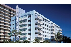 Standing on a street corner, this hotel boasts a unique architectural style with balconies on each floor.