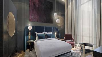A modern hotel room with a large bed, a round bedside table, a chair, and a desk.