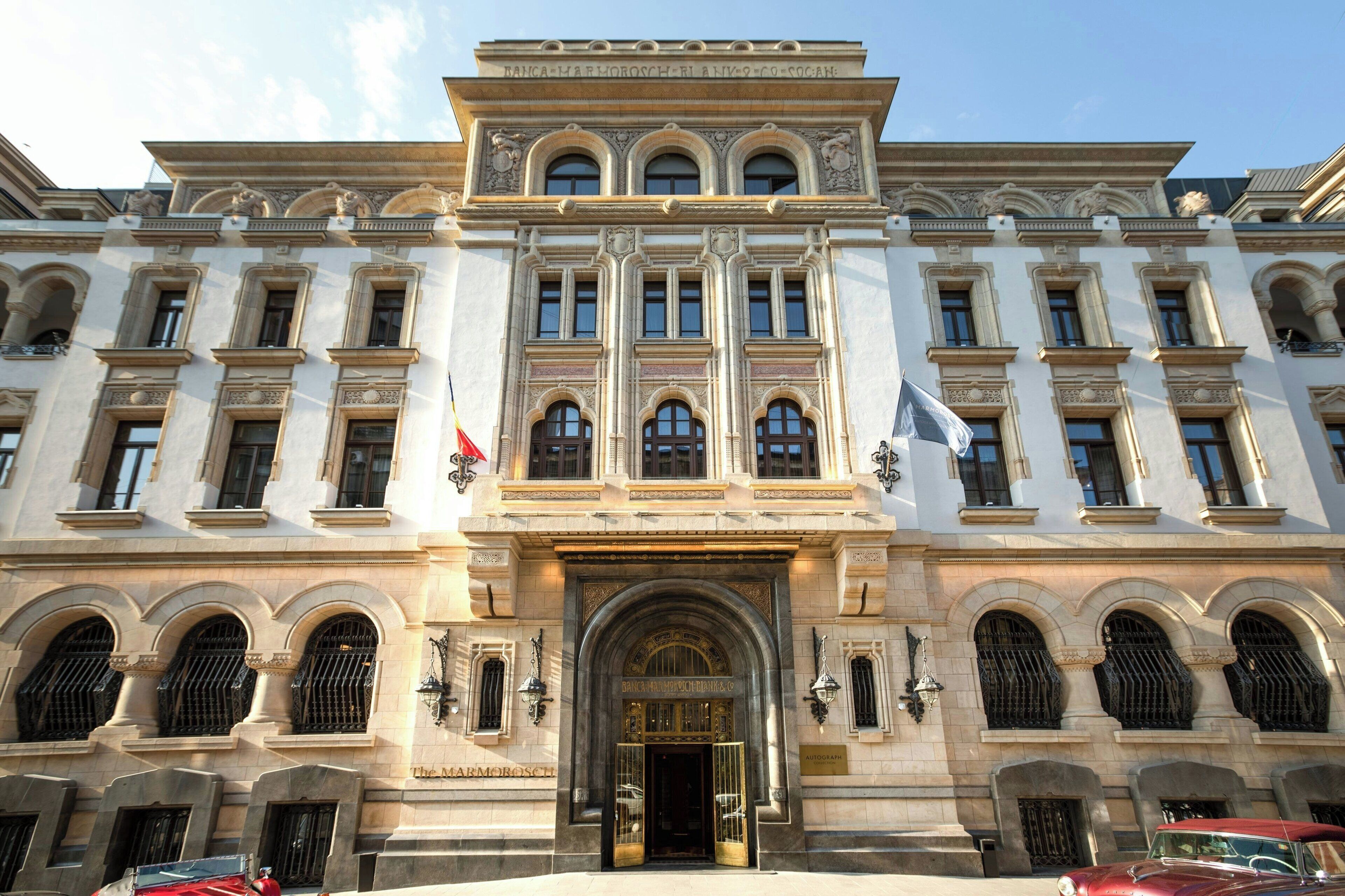 A historic building with a grand entrance, multiple windows, and classical architectural details.