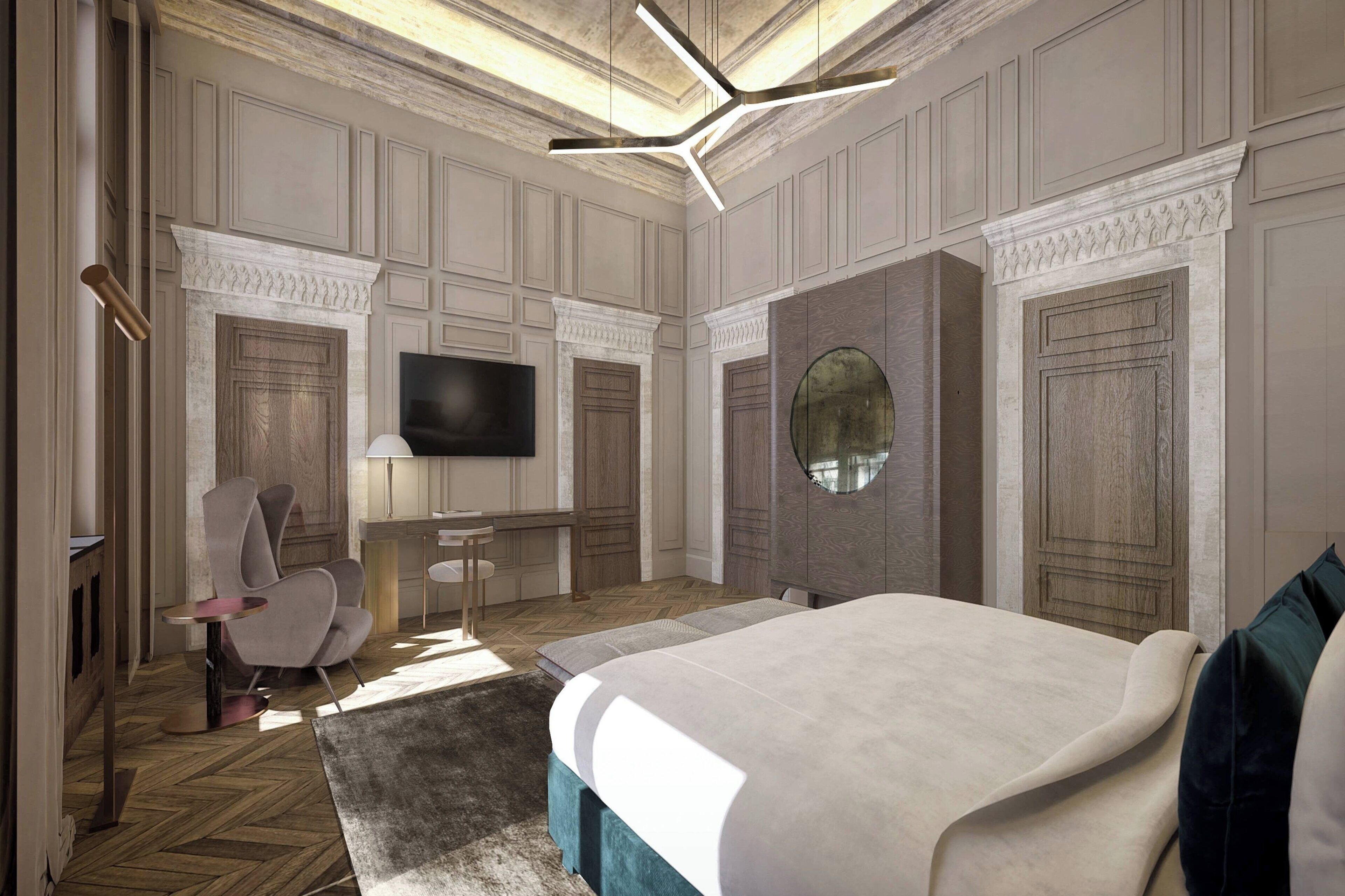 Un dormitorio moderno con una cama grande, un televisor montado en la pared y una zona de estar con una silla y una mesa.