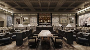 A luxurious hotel lobby with a central bar area, multiple seating arrangements, and a patterned floor.