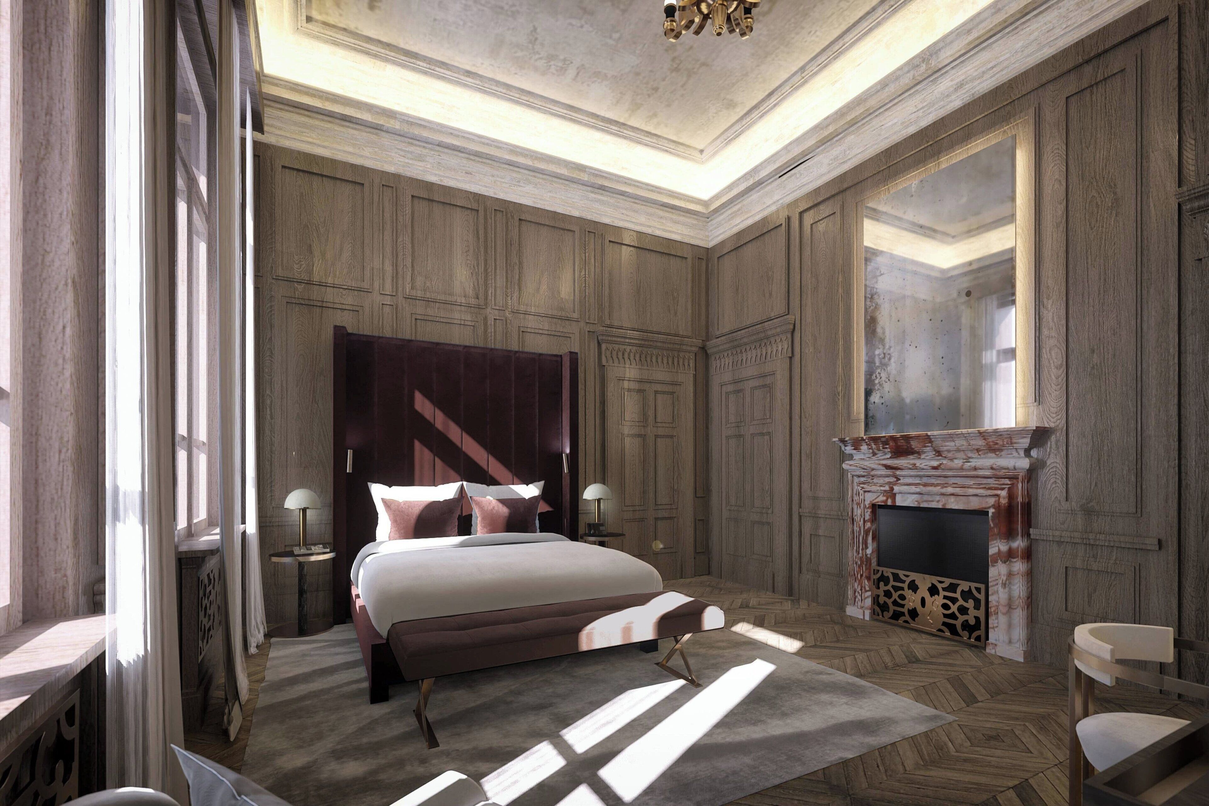 A spacious bedroom with a large bed, a fireplace, and a view of the city.