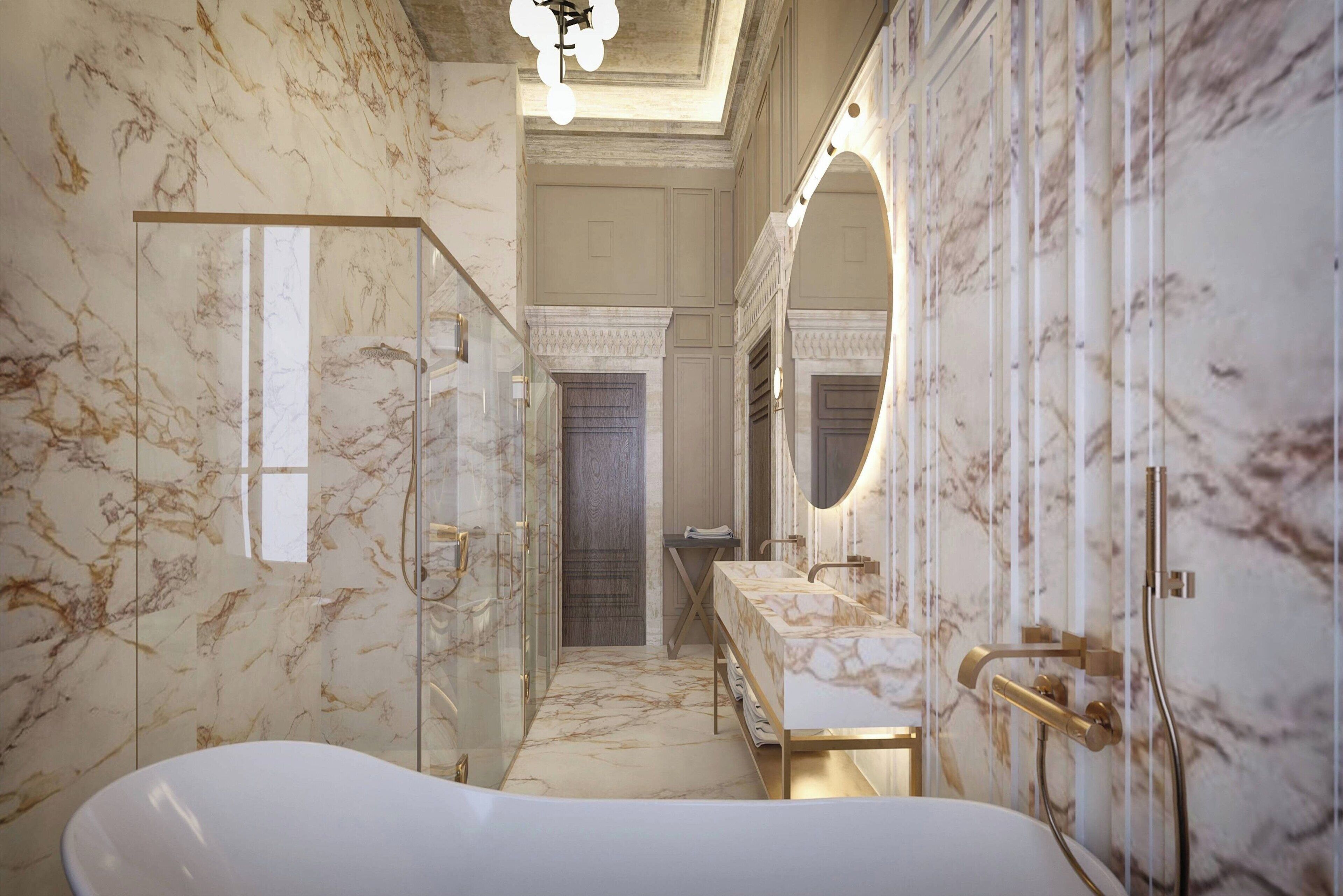A luxurious bathroom with marble walls, a freestanding bathtub, and a large mirror.