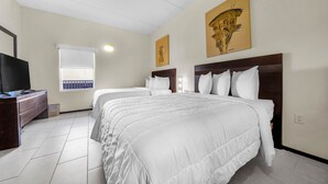 A hotel room with two beds, a television, and artwork on the walls. - Wonderful Three Bedroom Condo Partial Ocean Views (South Padre Island)