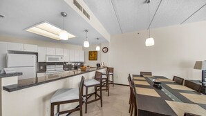 A modern kitchen with a central island, built-in appliances, and pendant lighting. - Wonderful Three Bedroom Condo Partial Ocean Views (South Padre Island)