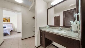 A modern bathroom with a large mirror, a sink, and a vanity. - Perfect Fully Furnished 3Bedroom Condo Ocean View  (South Padre Island)