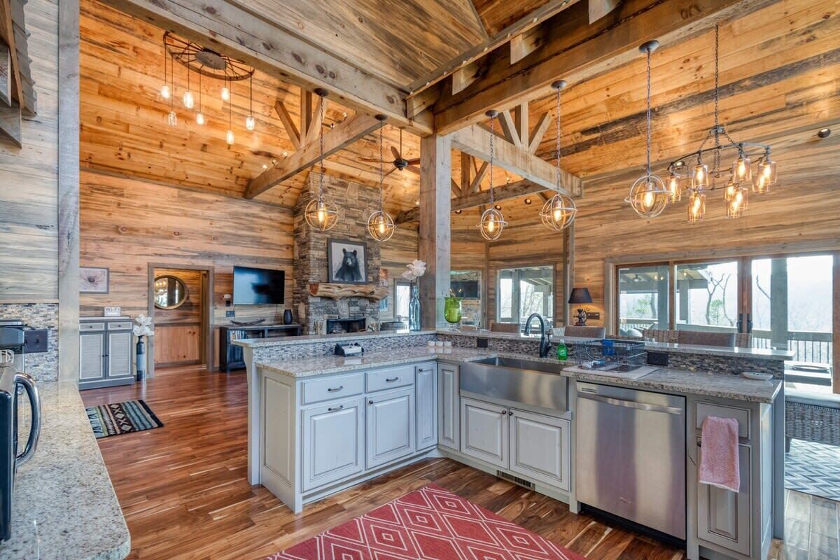 A spacious kitchen with granite countertops, white cabinetry, and a large island.