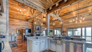 A spacious kitchen with granite countertops, white cabinetry, and a large island. - The Secret of Blue Ridge, SHHHH don't tell anyone! (Cherry Log)