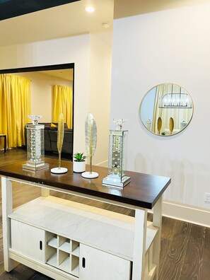 A modern interior with a wooden console table, a mirror, and decorative items.