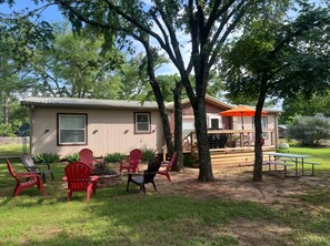 A house with a patio area, outdoor seating, and a deck.