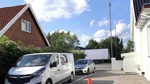 A parking area with a white van and a silver car parked. - Luxurious room nearby Copenhagen central (Rødovre)