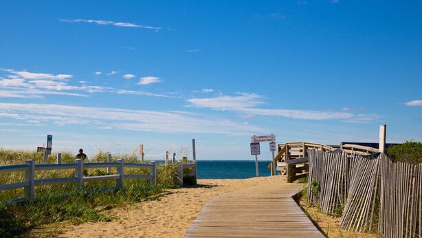 A wooden boardwalk leading to a beach with a sign indicating a no swimming area. - Cape Gem in New Seabury resort & near the beach. (Mashpee)