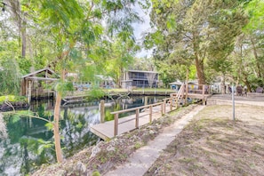 Escape to a serene lakeside haven with a tranquil dock and lush surroundings.