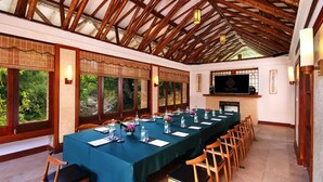 A conference room with a long table, chairs, and a television screen. - Crosswaters Ecolodge & Spa (Huizhou)