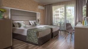 A hotel room with a large bed, a desk, and a chair. - Marina Sands Bijou Boutique is an Excell (Nessebar)
