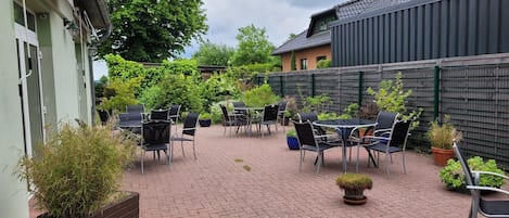 A patio area with outdoor seating and potted plants.