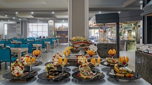 A hotel dining area with multiple tables set for a buffet, featuring a variety of food and drink options. - Miarosa Kemer Beach (Kemer)
