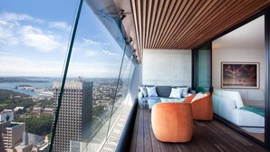 A balcony with a city view, a sofa, and a wooden ceiling. - Prestige City Chic I90 (Sydney)