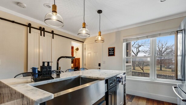 A modern kitchen with a large island, stainless steel appliances, and pendant lighting. - Walk to Broadway - Heart of downtown (Nashville)