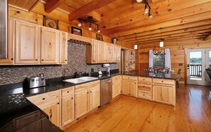 Enjoy cooking in this well-equipped kitchen with a double sink, oven, and dishwasher.