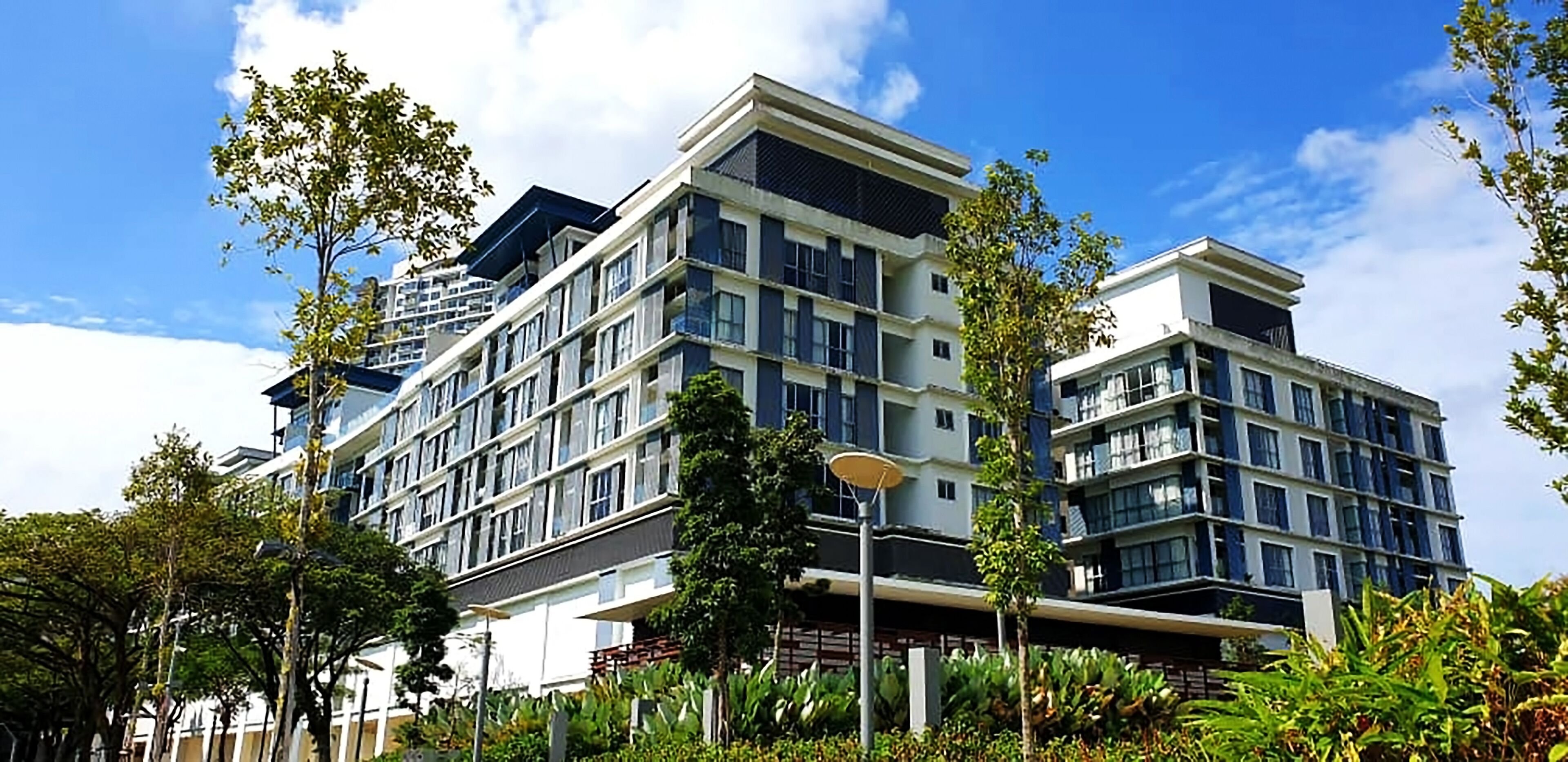 Ein mehrstöckiges Hotel mit moderner Architektur, mit Balkonen und großen Fenstern.