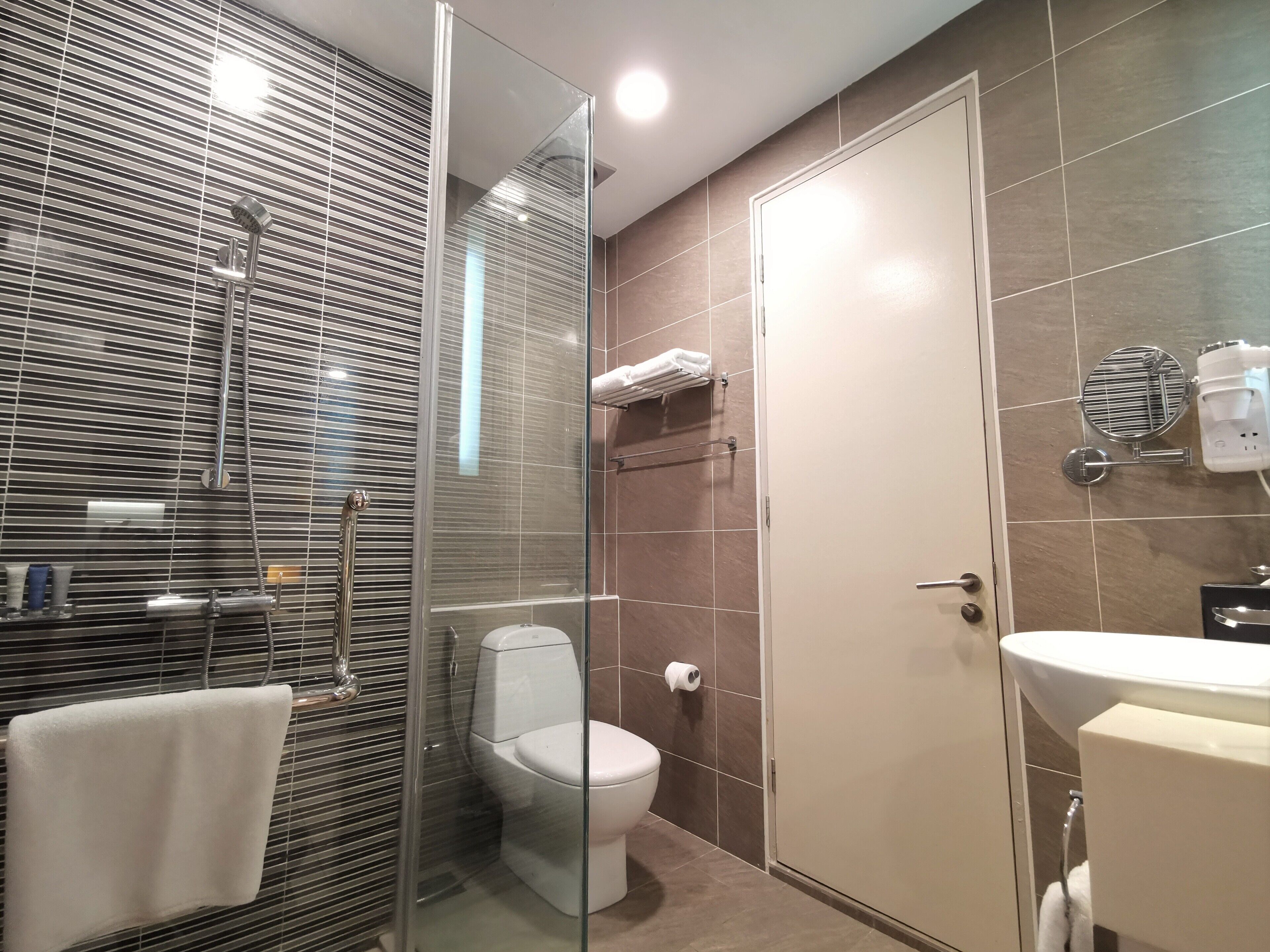 Ein modernes Badezimmer mit einer Duschkabine, einer Toilette und einem Waschbecken.