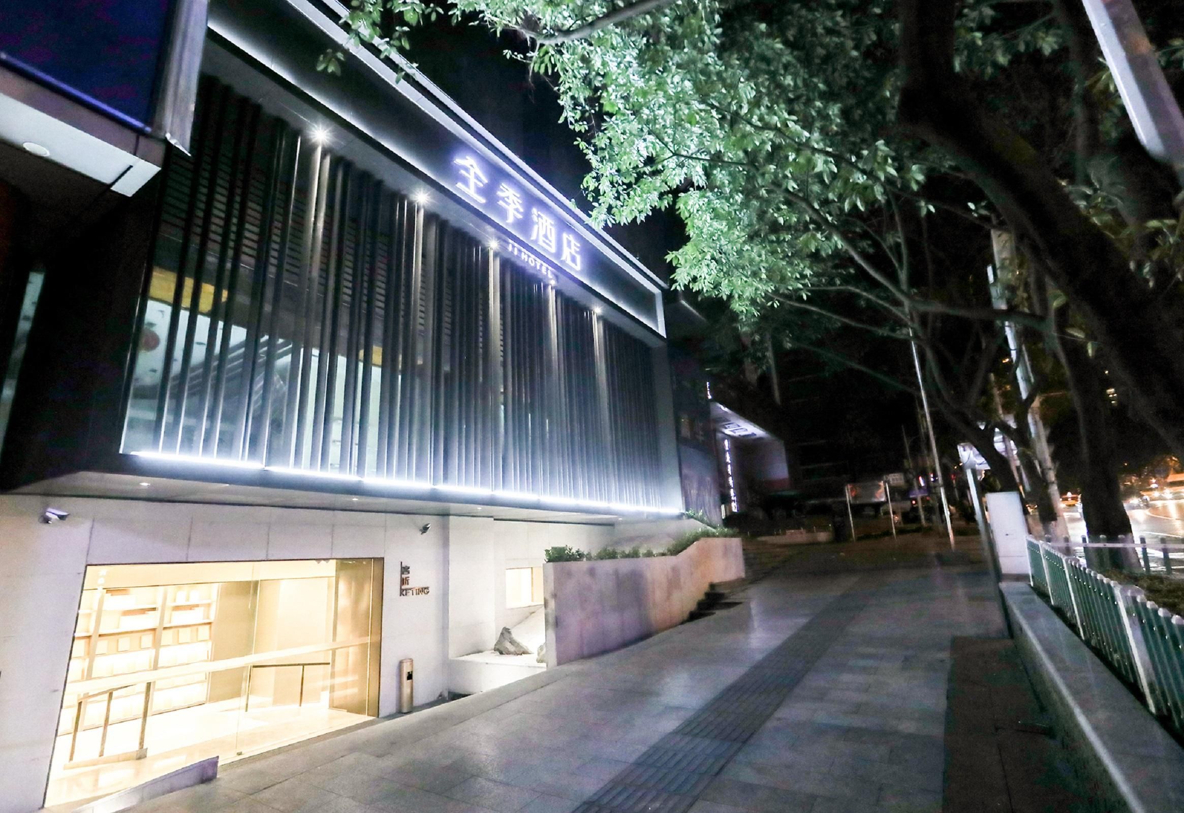 A hotel with a modern facade, large windows, and a well-lit entrance.