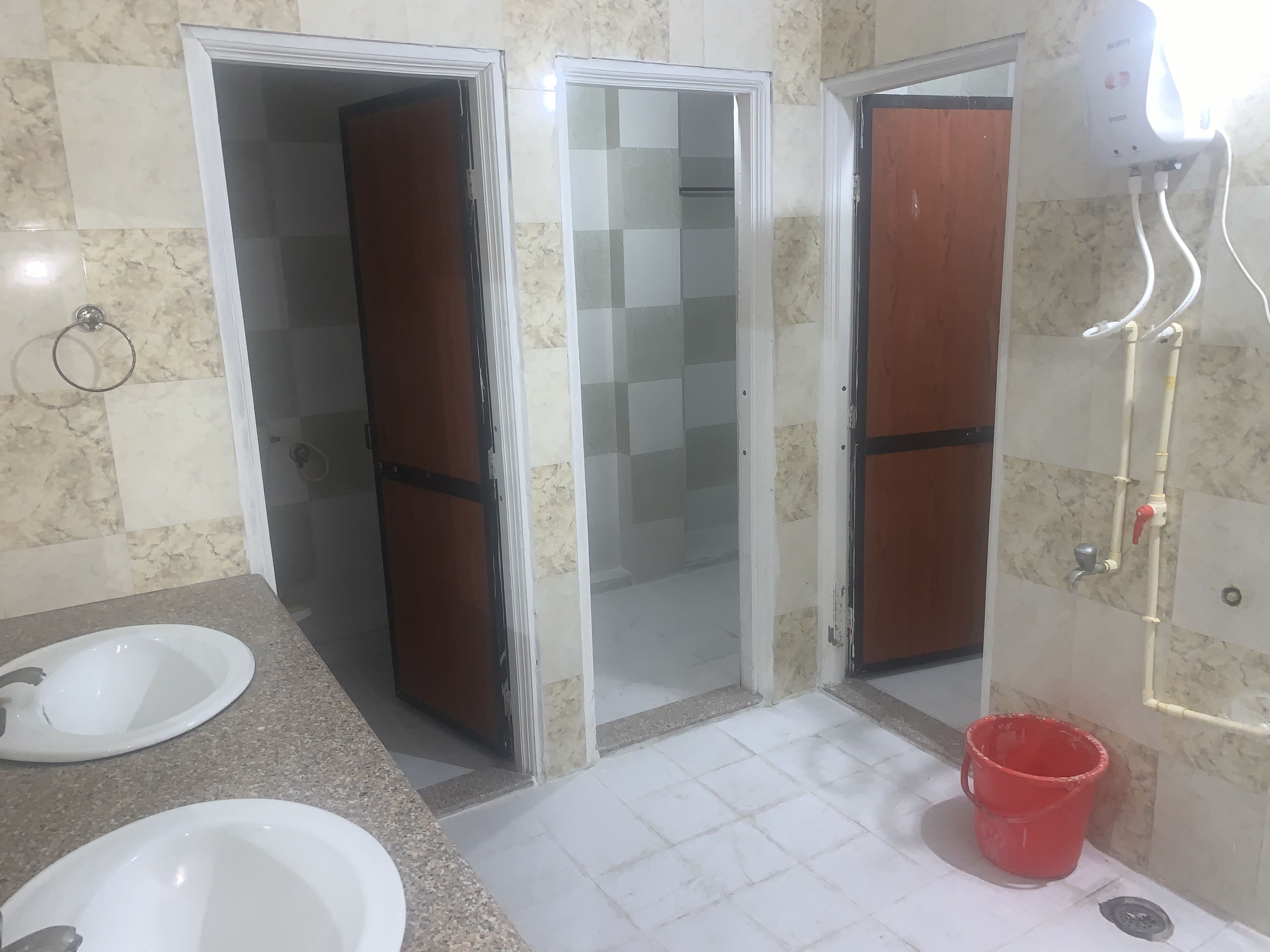 A bathroom with a sink, mirror, shower, and toilet.
