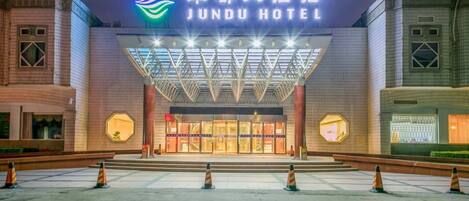 The exterior of Jindu Hotel with a prominent entrance and a large illuminated sign.