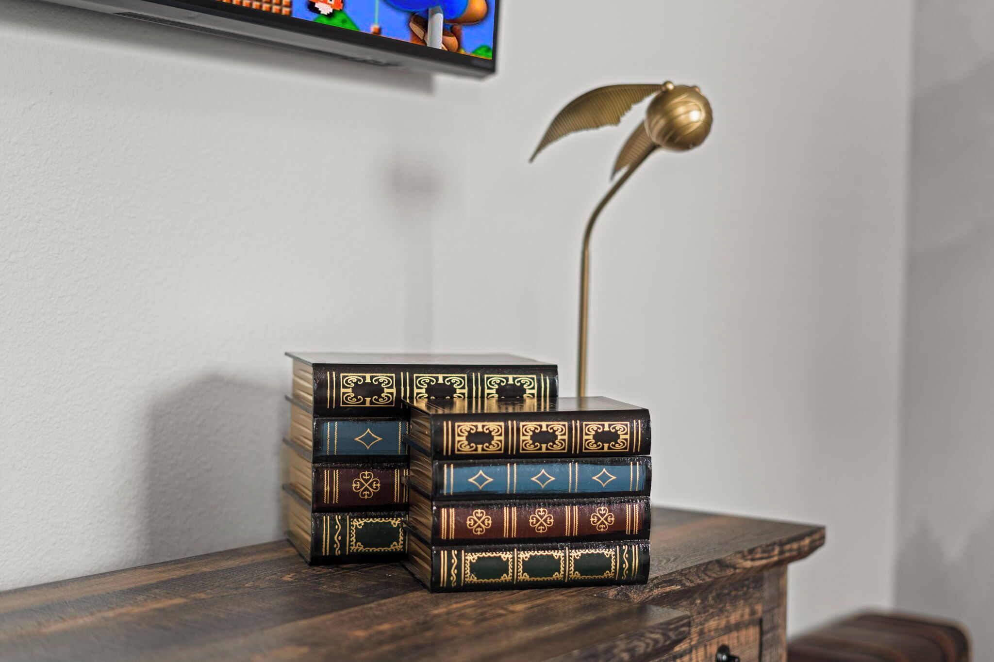 A wooden chest with intricate designs and a decorative lamp on a wooden surface.