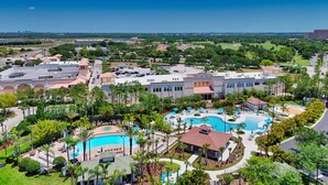 A resort with multiple swimming pools, a large parking area, and a view of the surrounding landscape. - Renovated Condo by Convention Center & I-drive (Orlando)